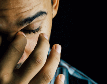 Man with a sinus infection holding nose