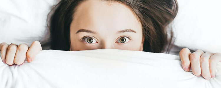 Woman laying down thinking about seeing a Doctor About Snoring